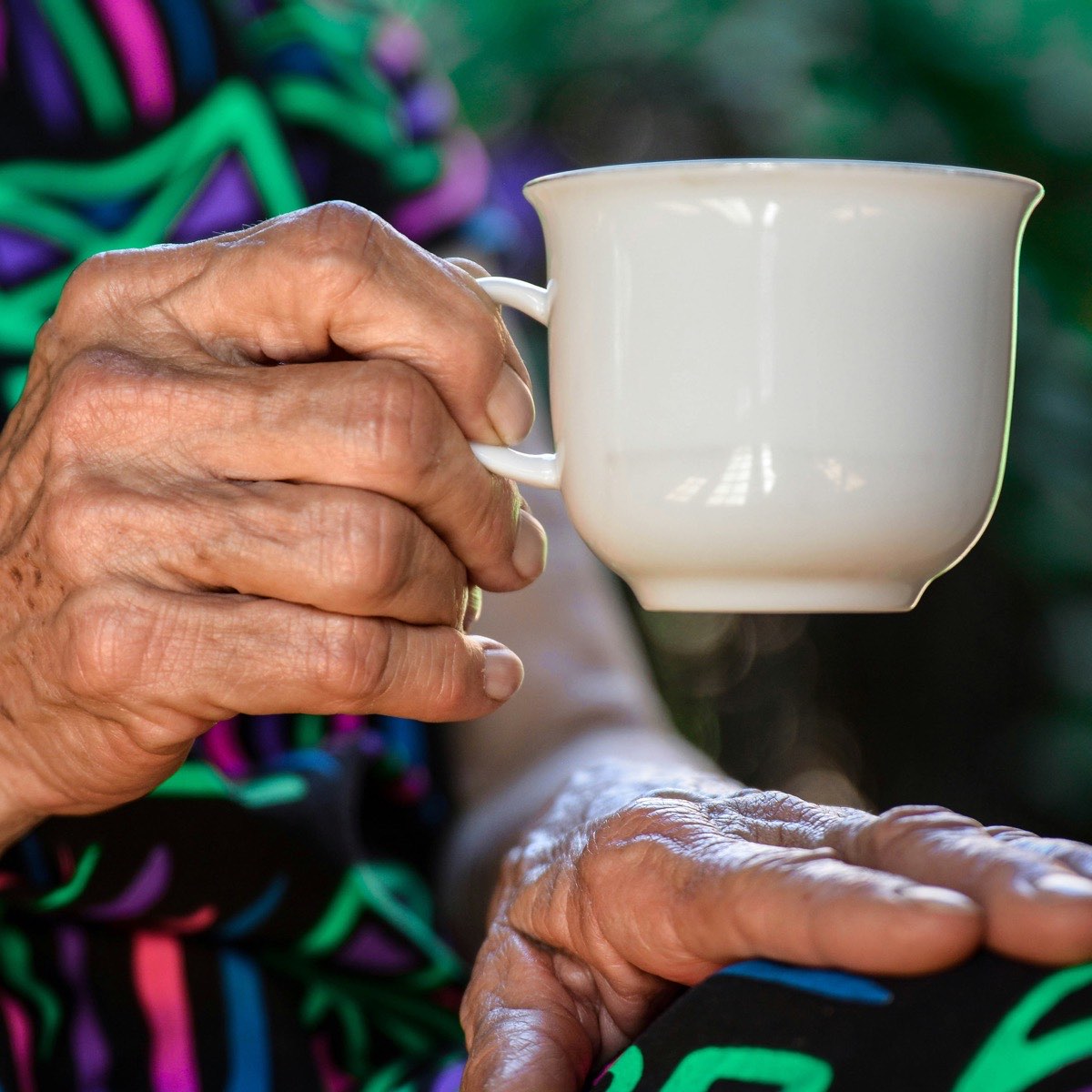 Placeholder: a person holding a cup of tea